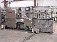 The shuttle consolidates and delivers a batch-at-a-time collection of product baskets to the retorts