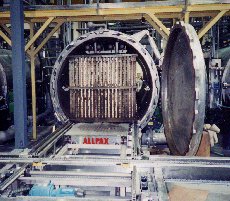 The Air Drone drives underneath the jumbo retort basket, then inflates to lift the basket off of the conveyor, and drives the basket to its target location.